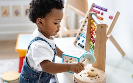 a young boy playing with a toy