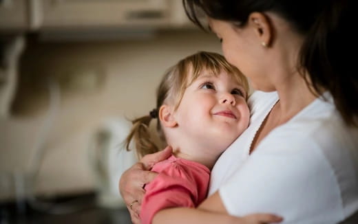 a woman holding a baby