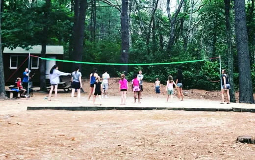 a group of people playing volleyball