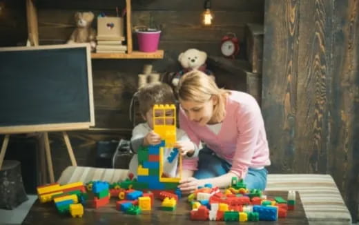 a person and a child playing with toys