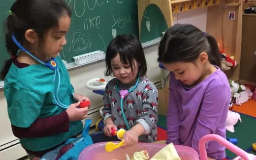 a group of children sitting at a table