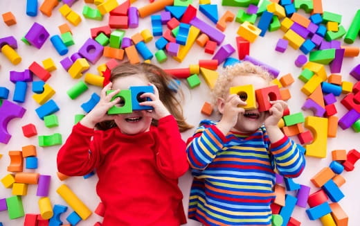 a couple of children playing with toys