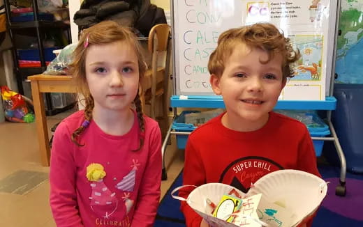 a couple of children sitting at a table