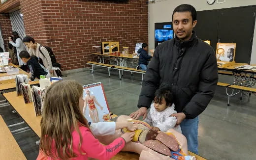 a man and a couple of kids at a table with a man and a woman