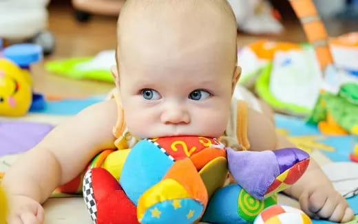 a baby lying on a blanket