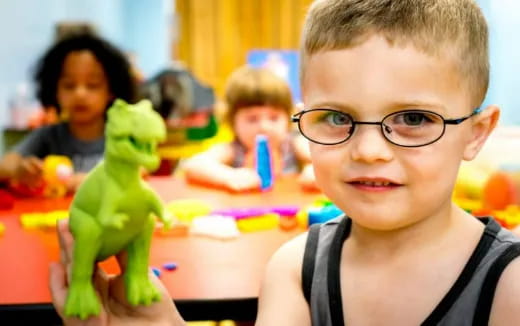 a boy holding a toy