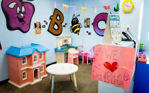 a child's room with a playroom and a table