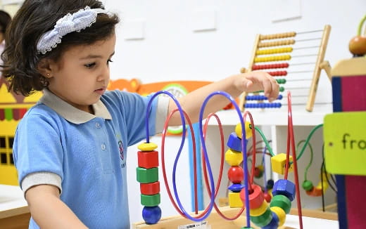 a young girl with a basket of colorful balls