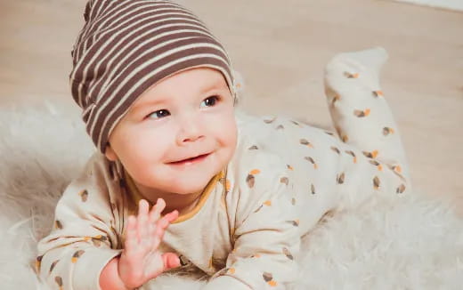 a baby lying on a blanket