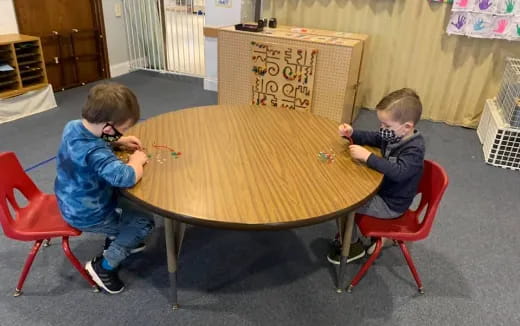 two boys sitting at a table