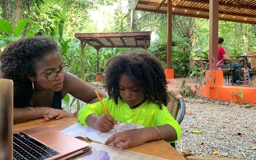 a person and a girl studying outside