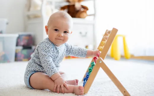 a baby holding a toy sword
