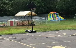 a black and white object on a stand in a parking lot