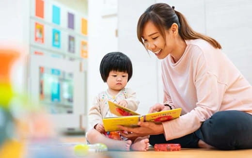 a person and a child looking at a tablet