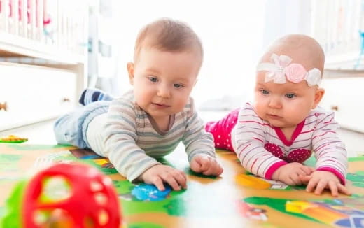 two babies playing with toys