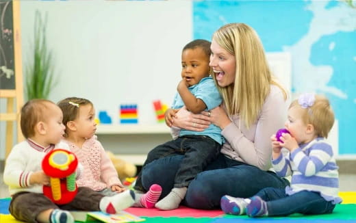 a person and several children sitting on the floor