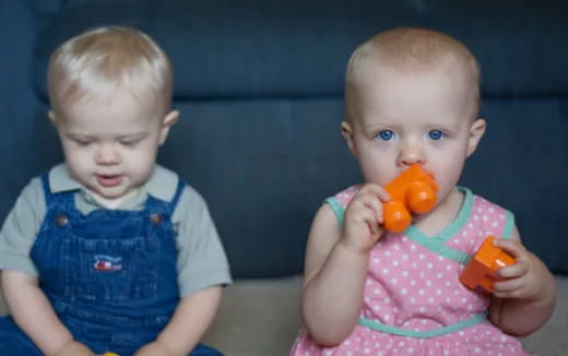 a couple of babies holding toys