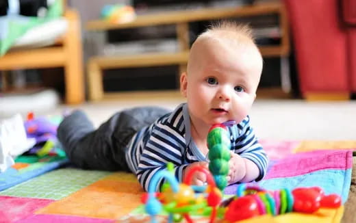 a baby lying on the floor