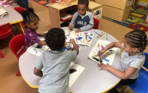 a group of children sitting at a table