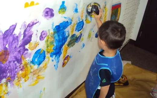 a child painting on a wall