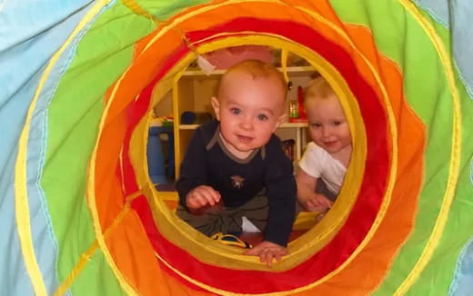 a couple of babies in a slide