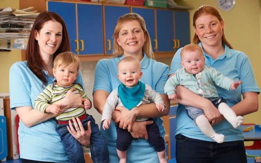 a group of women holding a baby