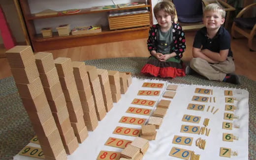 two boys sitting on a rug