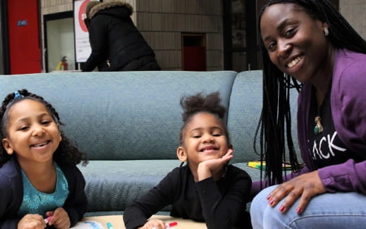 a person and two children sitting on a couch