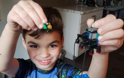 a boy with a green object on his head