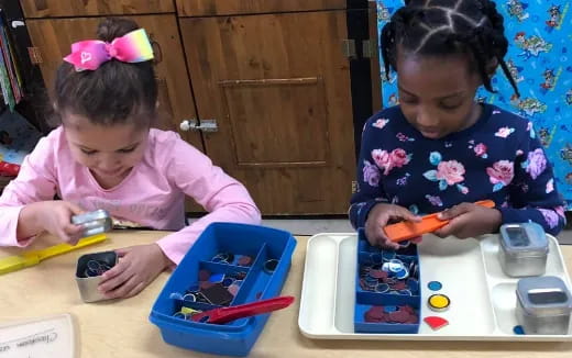 a couple of young girls playing with toys