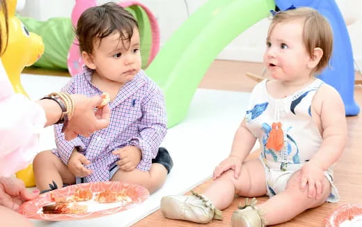 a couple of young children eating