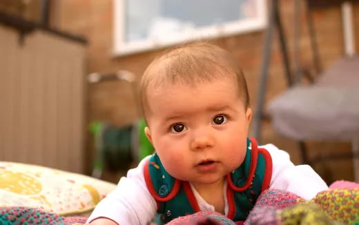 a baby looking at the camera