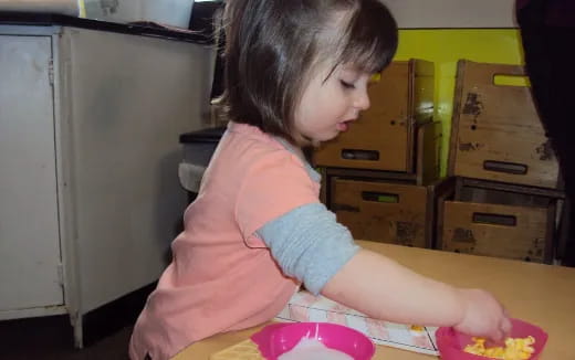 a girl sitting at a table