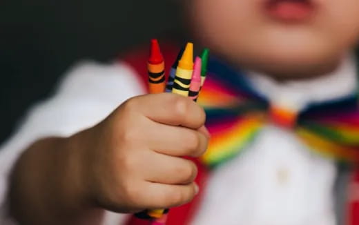 a child holding a pencil