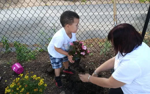 a person and a child planting flowers