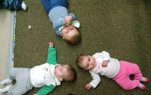 a group of babies lying on the ground