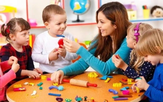 a person and children playing with toys