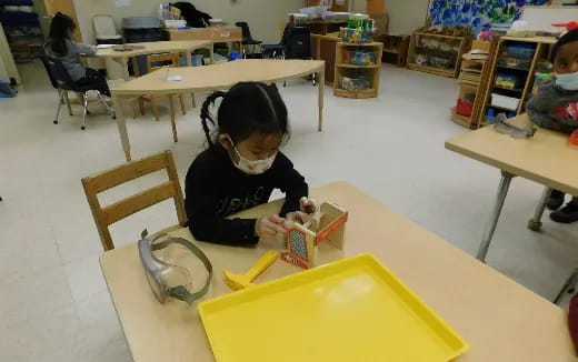 a young girl sitting at a desk