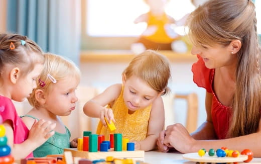 a group of children sitting at a table