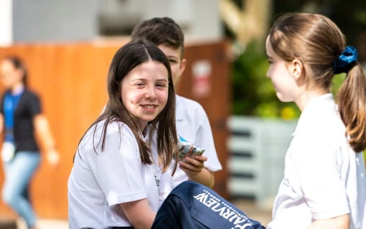 a person smiling at another woman