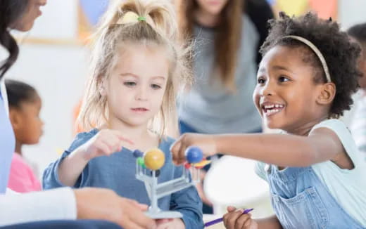 medium shot of kids holding a toy