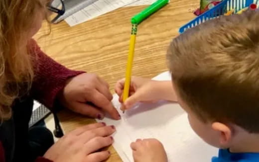 a child drawing on a paper