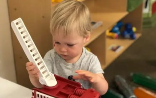 a child holding a white object