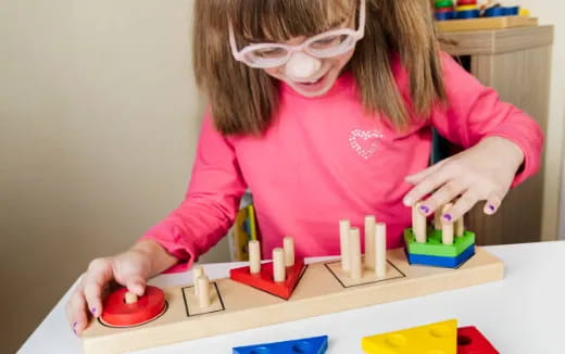 a girl playing with building blocks