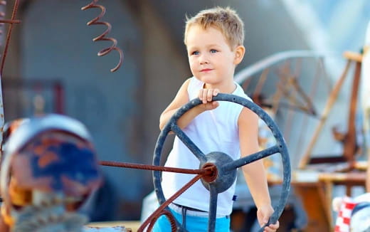 a boy holding a bow and arrow