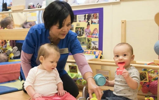 a person feeding a group of babies