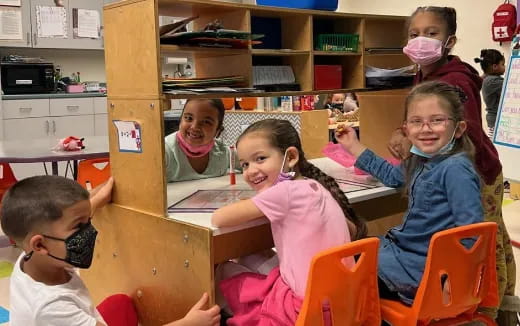 a group of children sitting at a table