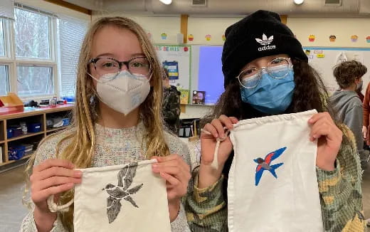 a couple of people wearing masks and holding a flag