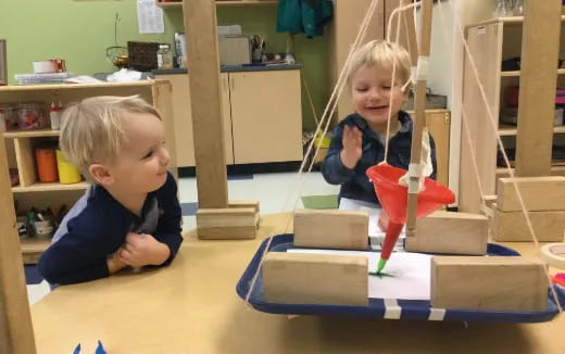 a couple of children playing with building blocks