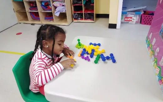 a girl playing with toys